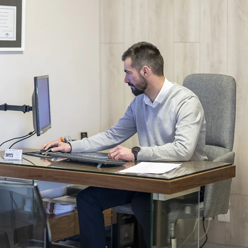 Conseiller funéraire travaillant sur ordinateur dans un bureau d'accueil